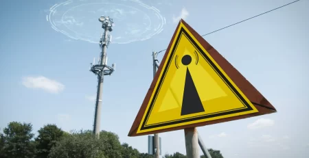 emf-warning-sign-5g-tower-causing-radiation-blue-sky